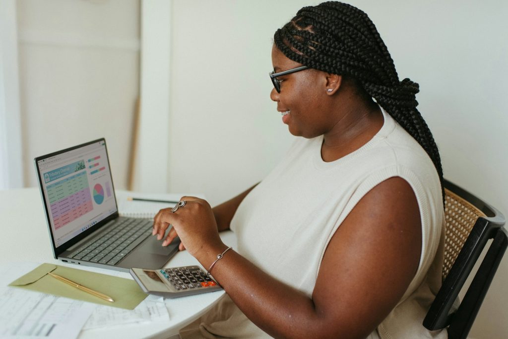 Business owner reviewing financial charts on her laptop