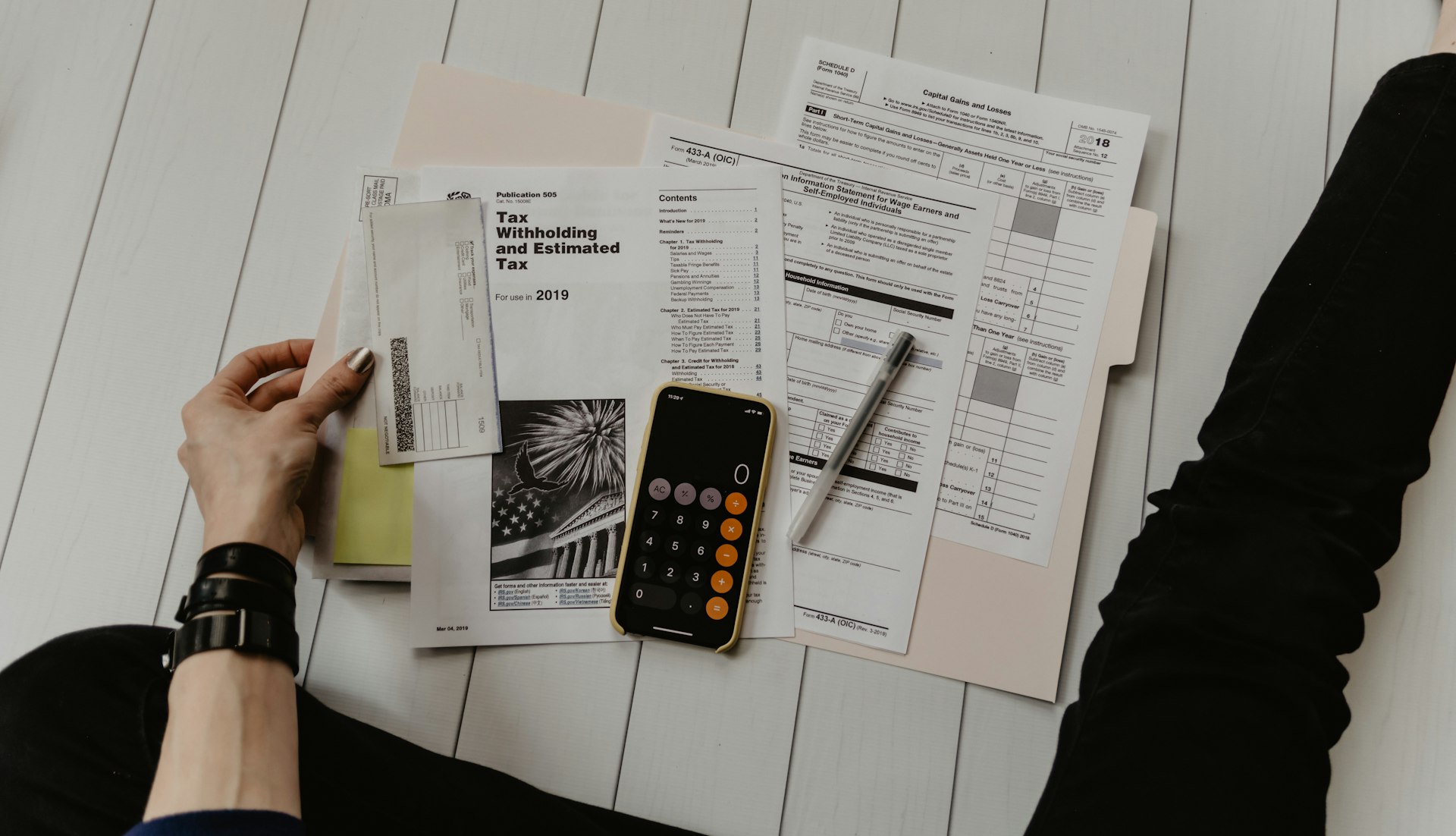 Reviewing tax documents with a calculator
